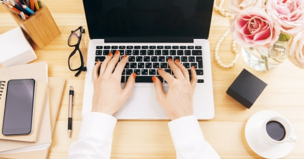 Start and Grow a Health Coach Email Newsletter. Female hands typing on a laptop.