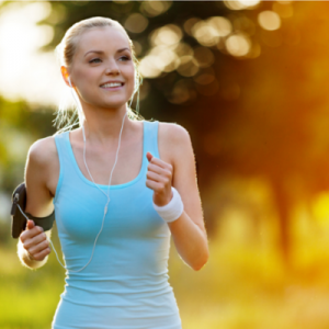 How to Create an Online Wellness Challenge – Whole Family Coaching. Woman running outdoors wearing an activity tracker.